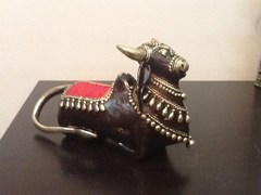 brass cow with red saddle