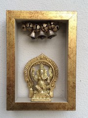 Golden Ganesh sitting on Throne in Golden Frame